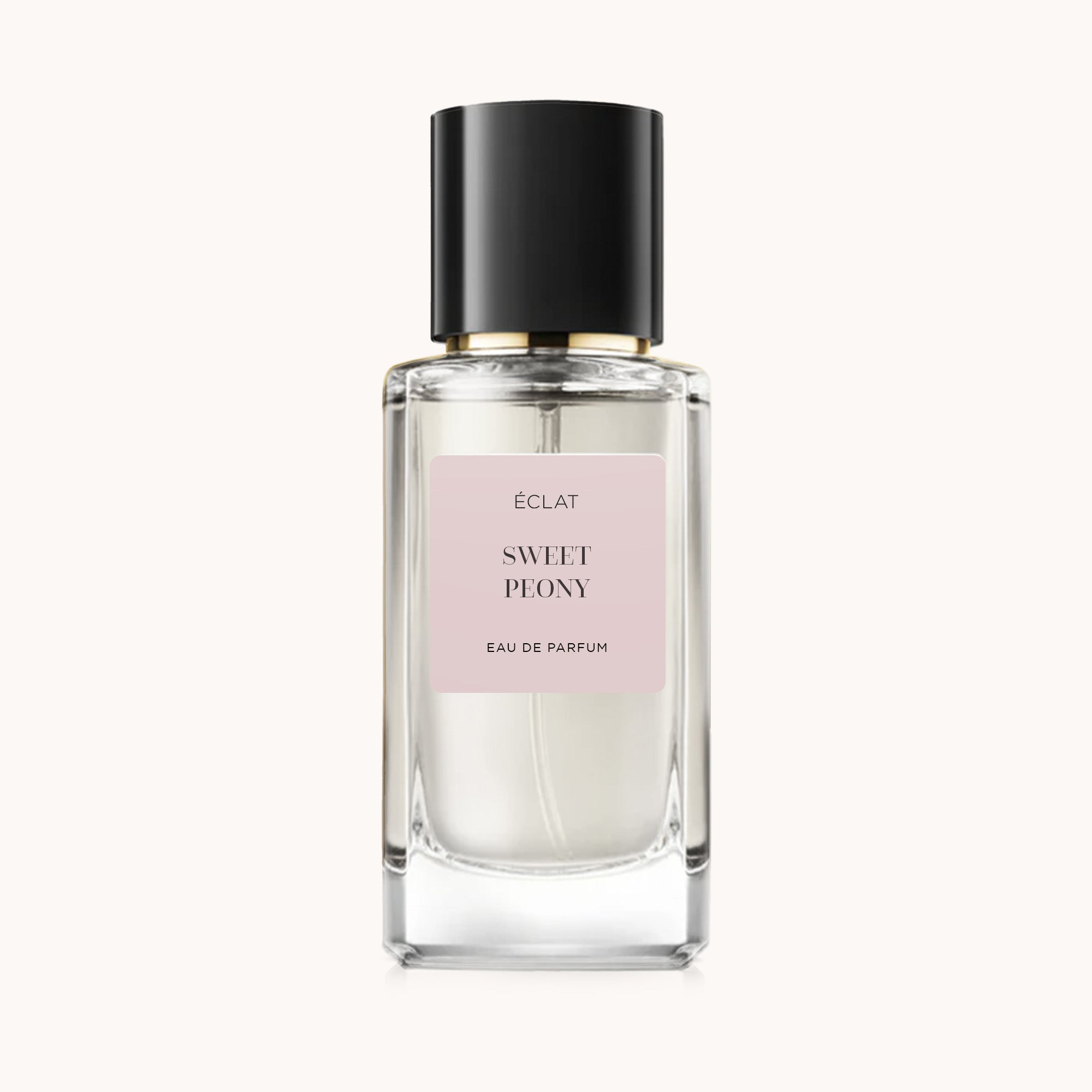 Elegant ÉCLAT Sweet Peony perfume in a clear glass bottle with a black cap and a soft pink label.