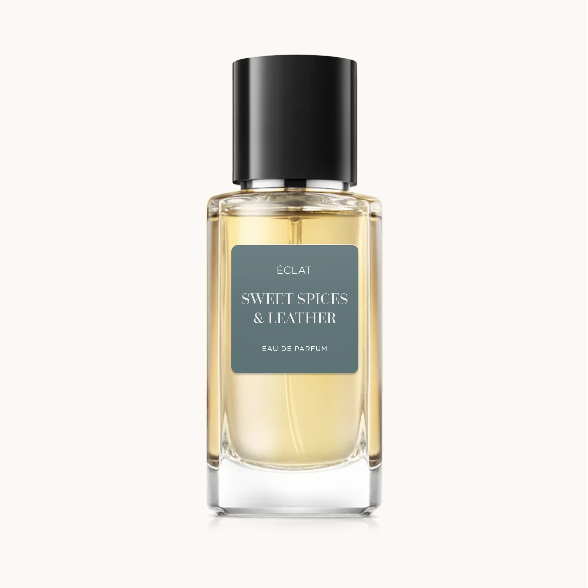 Faceted glass bottle of ÉCLAT Sweet Spices & Leather with black cap and matte label.
