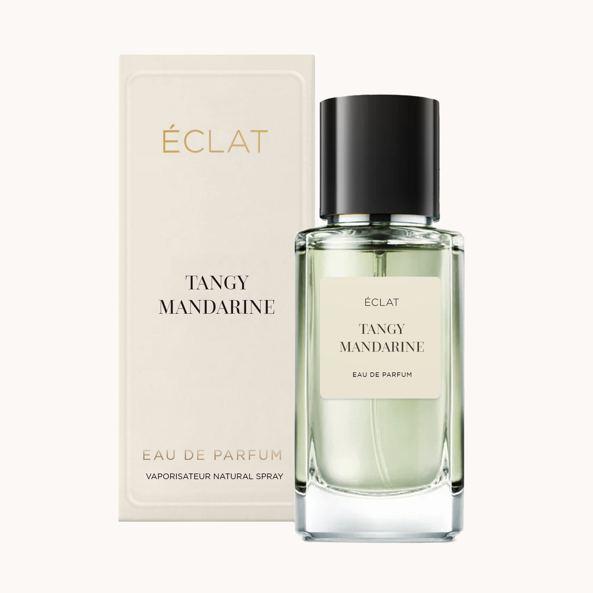 Faceted glass bottle of ÉCLAT Tangy Mandarin with a black cap, beside its elegant cream-colored box.