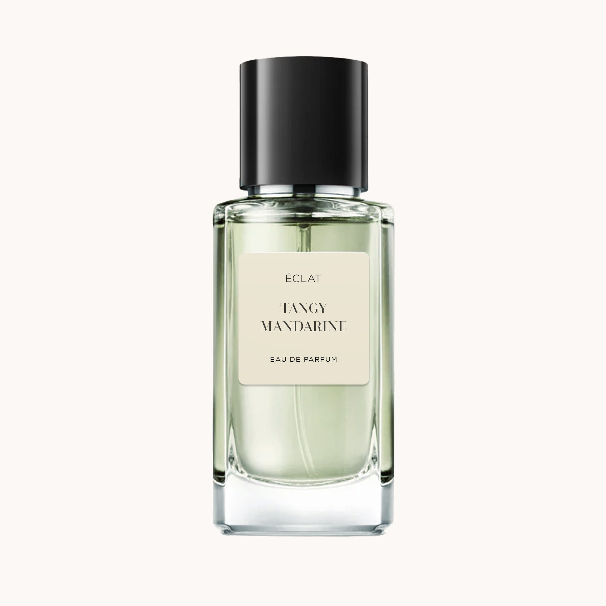 A clear glass bottle of ÉCLAT Tangy Mandarine perfume with a black cap and cream label.