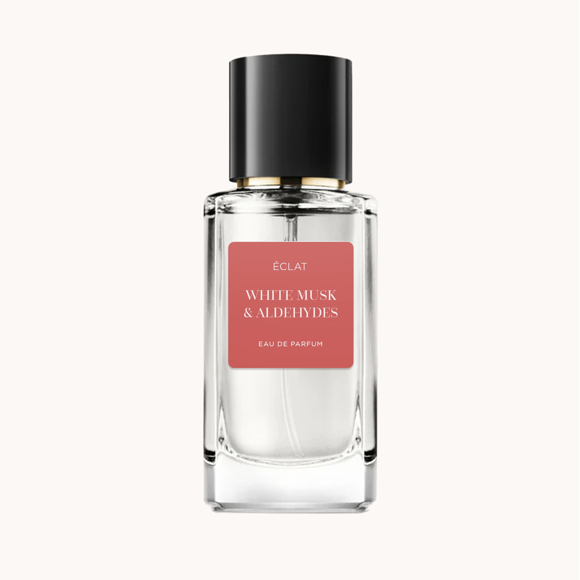 ÉCLAT White Musk & Aldehydes in a clear faceted glass bottle with a black cap and a matte pink label.