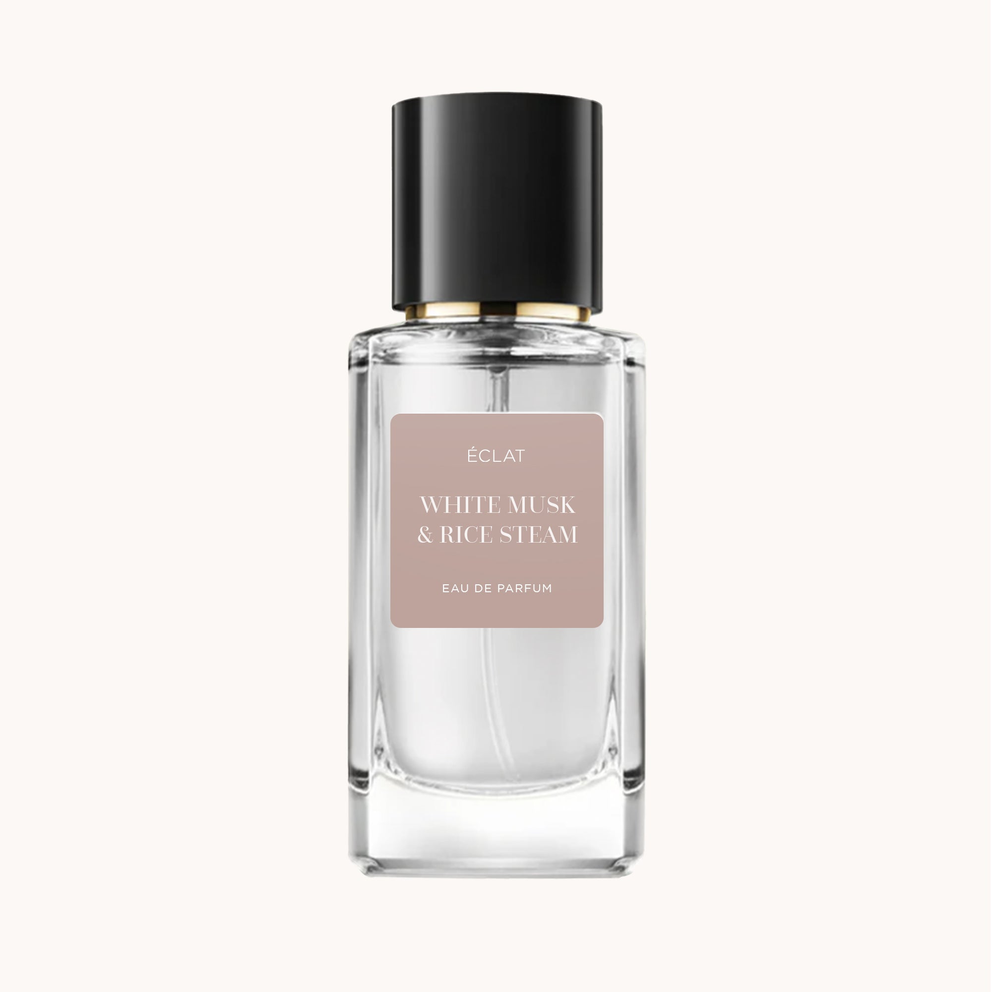 Faceted glass bottle of ÉCLAT White Musk & Rice Steam with a black cap and a matte label.