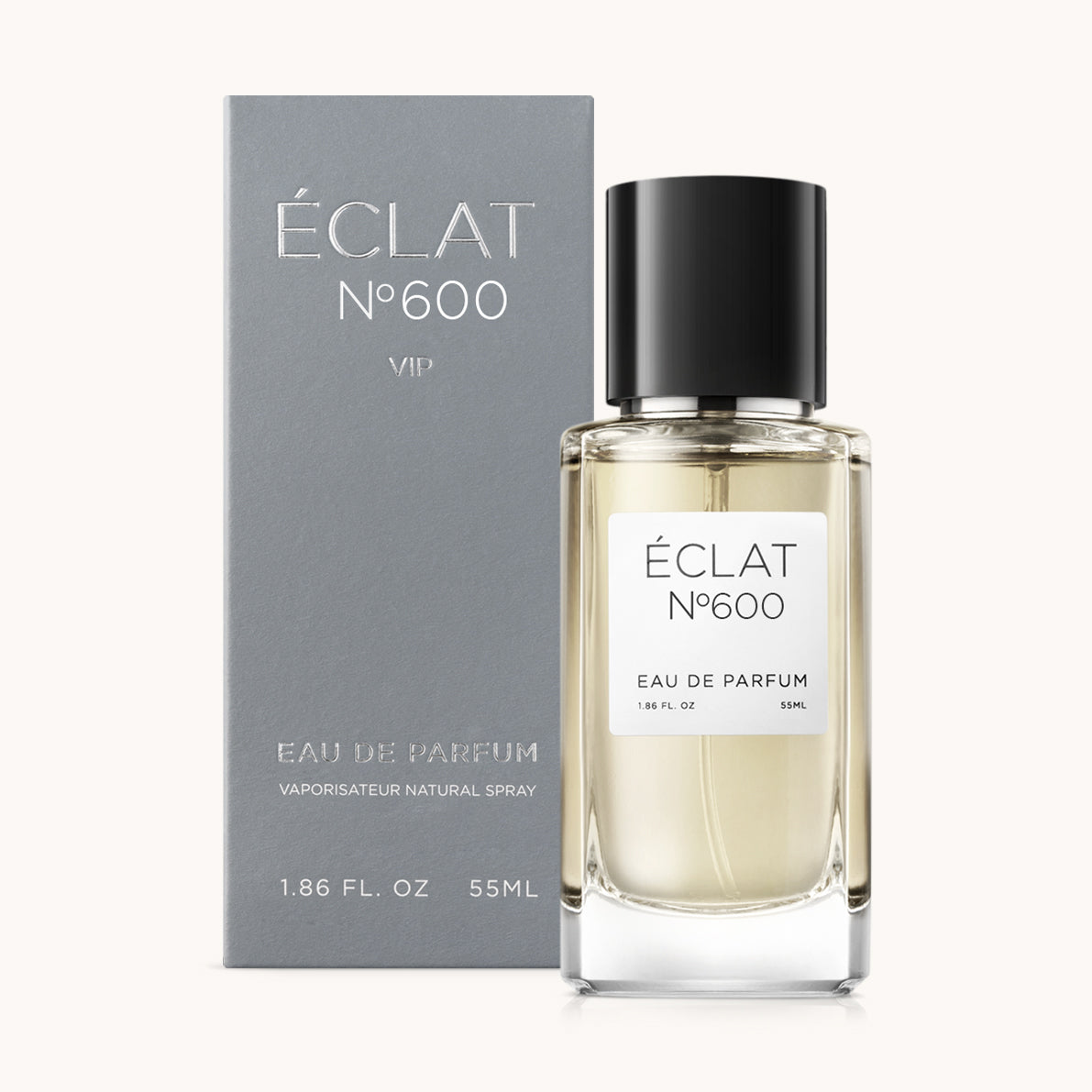Perfume ÉCLAT 600 VIP Woody Pineapple con frasco de vidrio claro y tapa negra, junto a una caja gris.